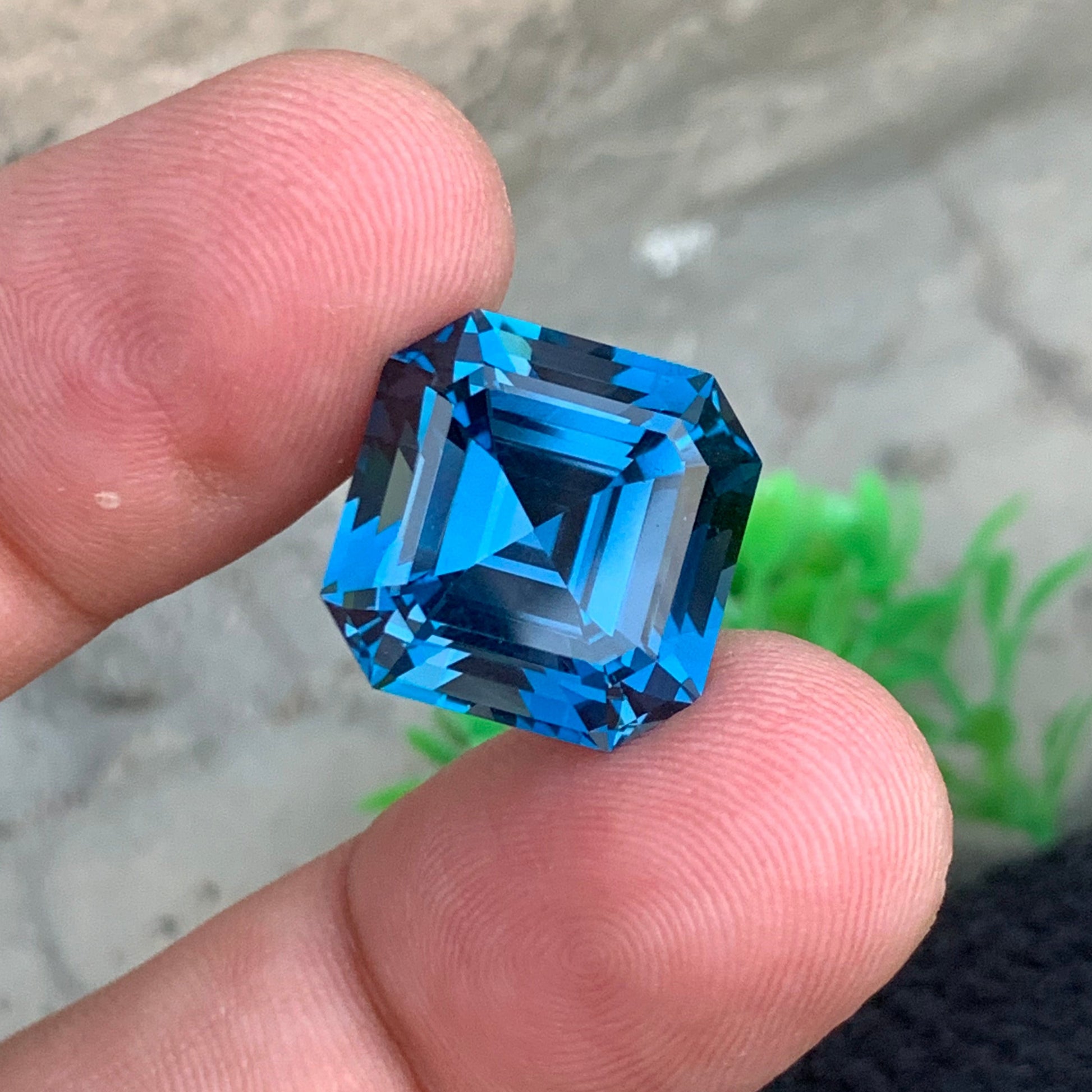 London Blue Topaz ring
London Blue Topaz pendant
Asscher cut London blue topaz loose gemstone close view
deep blue topaz 23 carat statement jewelry stone