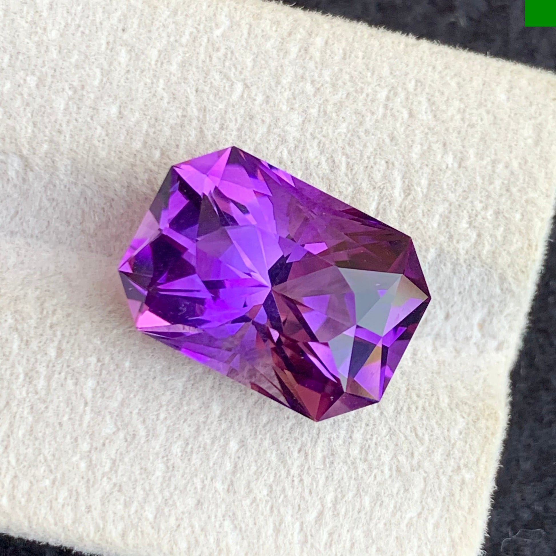 Purple gemstone on a white fabric background