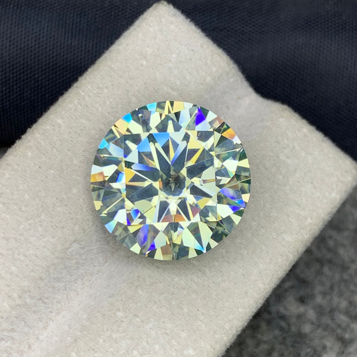 Large white moissanite loose stone on white background
Round cut gemstone dimensions 17.02 x 17.02 x 9.95mm
