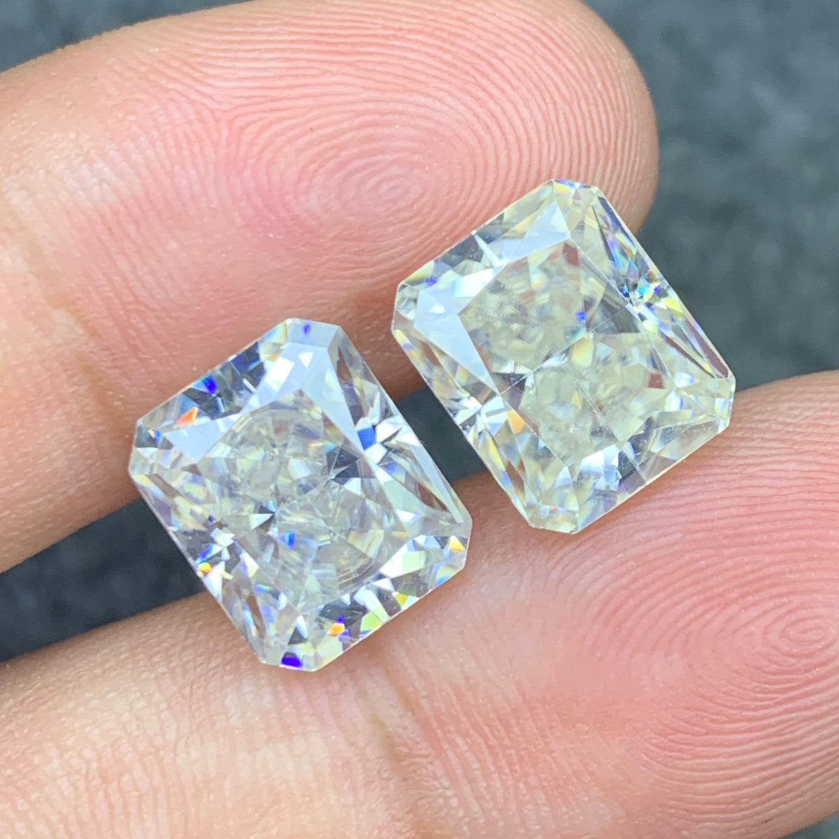 Long cushion cut moissanite pair side profile
White moissanite pair showing clarity close-up