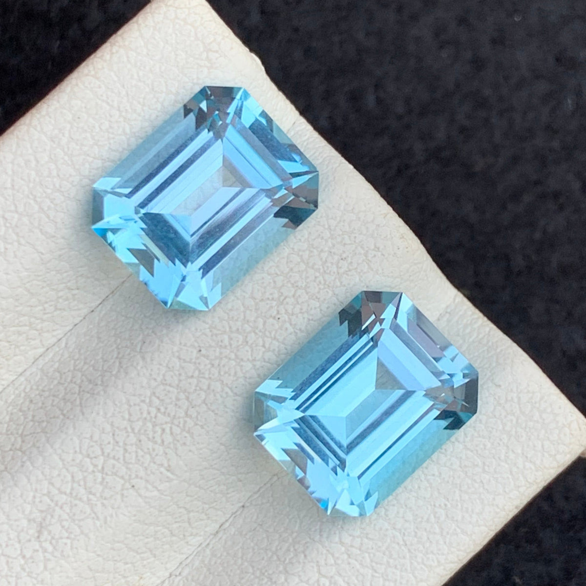 Swiss blue topaz gems
Swiss blue topaz pair
Electric Blue Topaz
Matching Swiss blue topaz gemstones for earrings top view
Loose emerald cut blue topaz pair VVS clarity