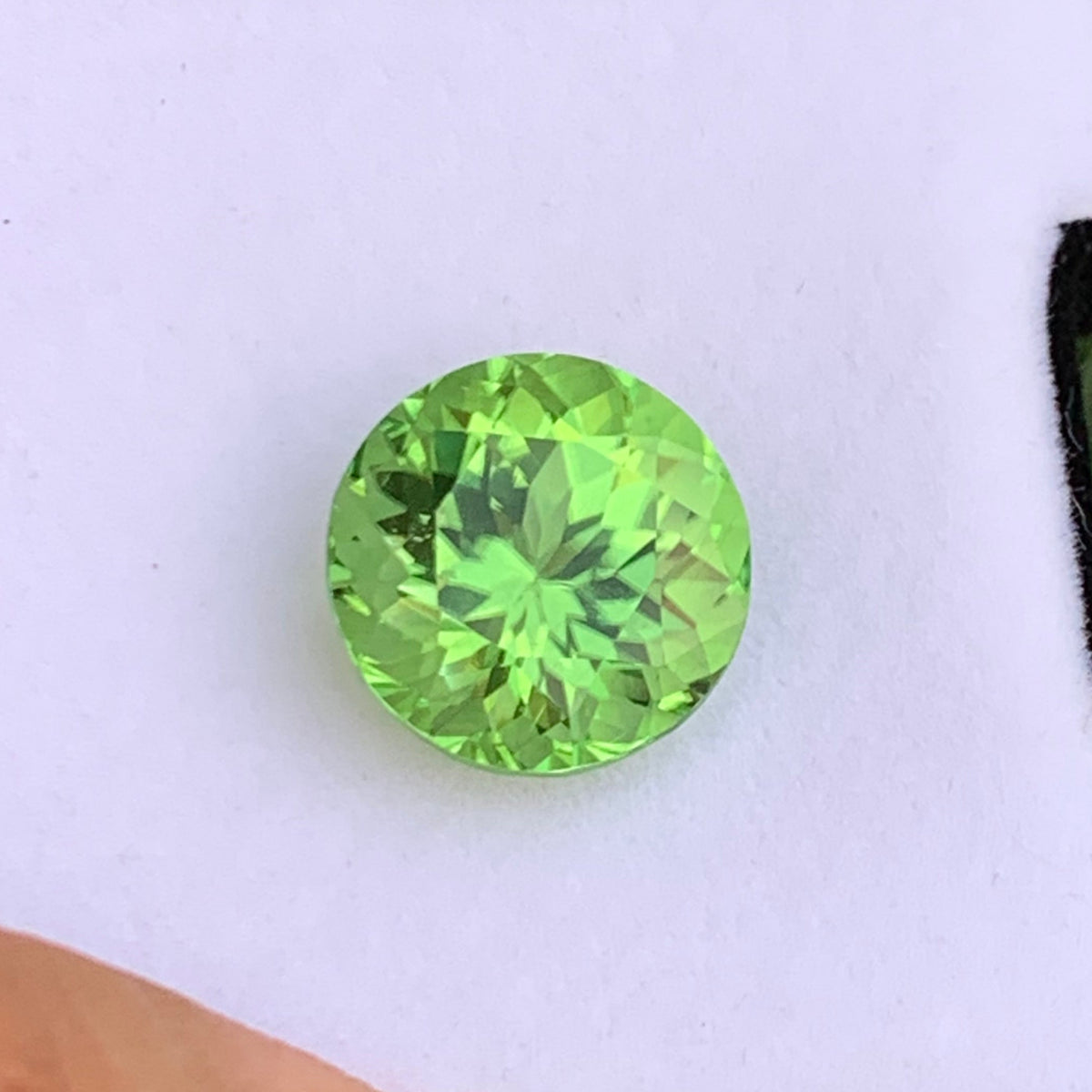 Round cut peridot side profile showing brilliance
Pea green peridot eye clean clarity close-up