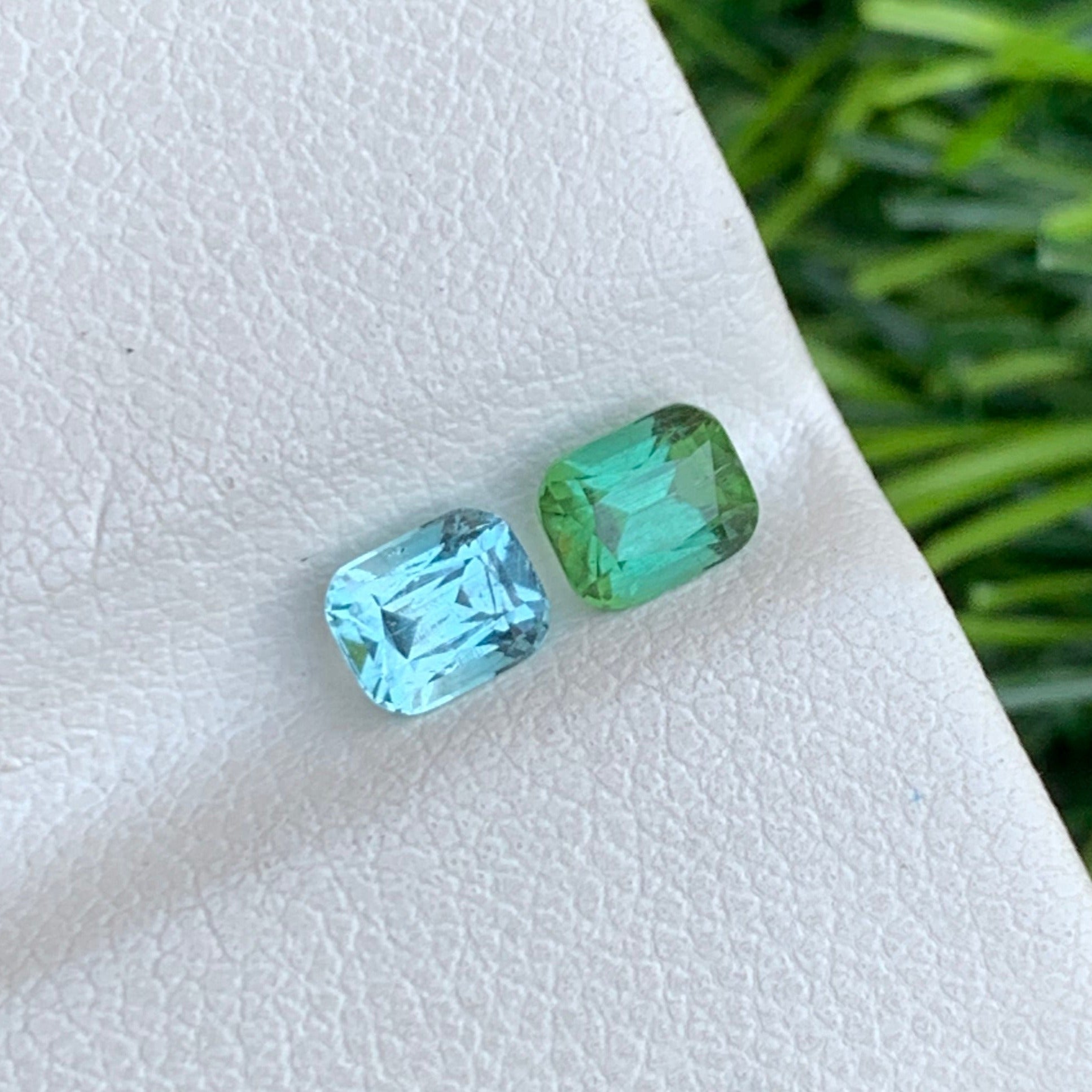“Reverse tourmaline pair backlit to highlight teal‑green hues
