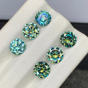Yellowish Green Moissanite set
Yellowish Green Moissanite lot
Round cut bluish green moissanite side profile
Bluish green moissanite eye clean clarity close-up