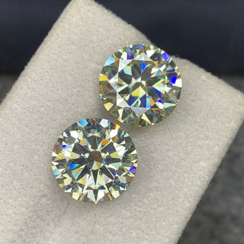 Round cut moissanite pair side profile showing brilliance
White moissanite pair VVS clarity close-up