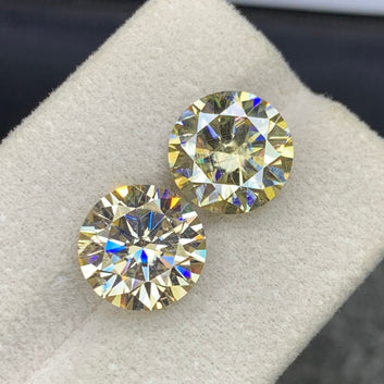 Round cut moissanite pair side profile showing sparkle
Light golden moissanite slightly included clarity close-up
