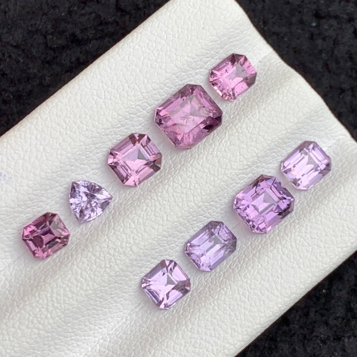 Spinel lot on white background showing color range
Spinel lot dimensions and size range comparison