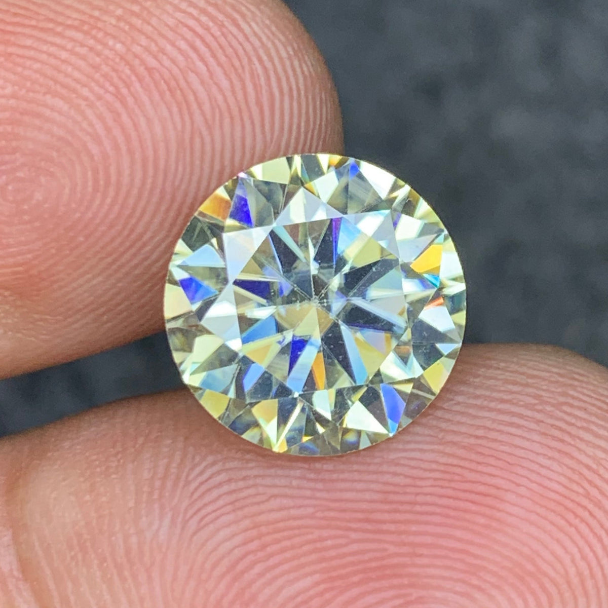 White moissanite held for scale
Moissanite reflecting light showing diamond-like fire