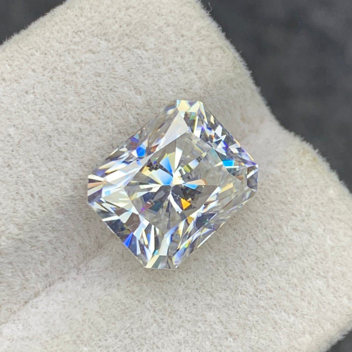 White moissanite loose stone on white background
Long cushion cut gemstone dimensions 12.01 x 9.99 x 7.16mm