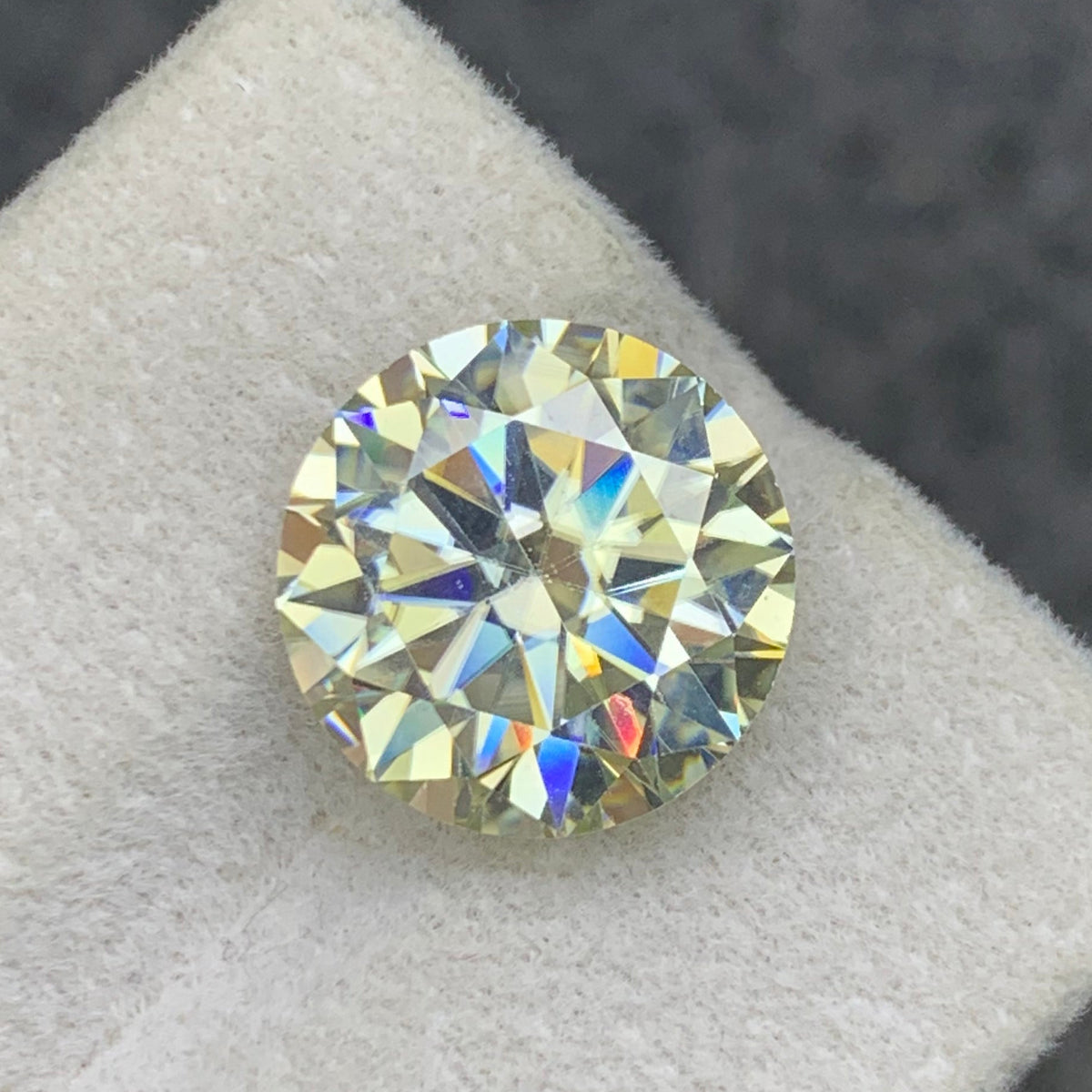 White moissanite loose stone on white background
Round cut gemstone dimensions 12.11 x 12.11 x 7.31mm