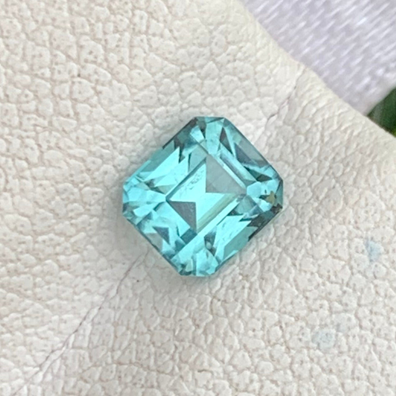 blue green tourmaline cushion shape
lagoon tourmaline gemstone close up
