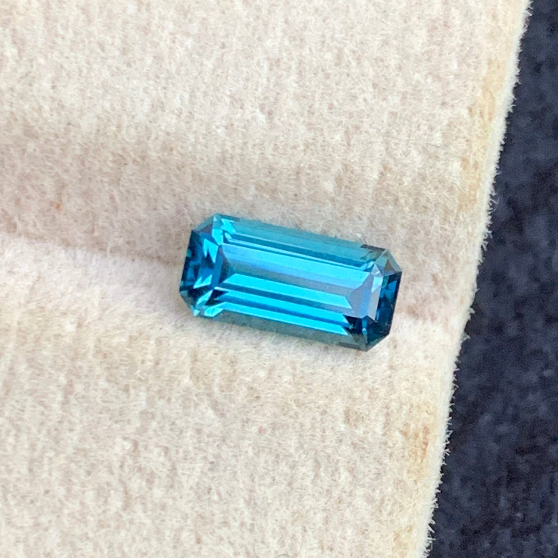 emerald cut blue tourmaline deep color close up