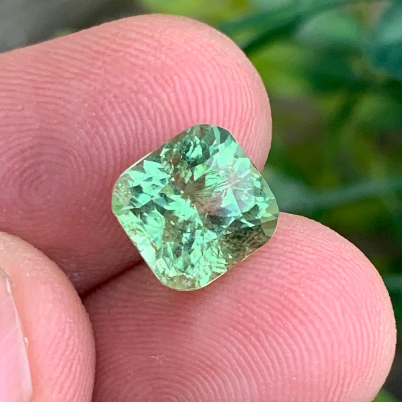 green tourmaline gemstone for rings
natural cushion cut tourmaline close up