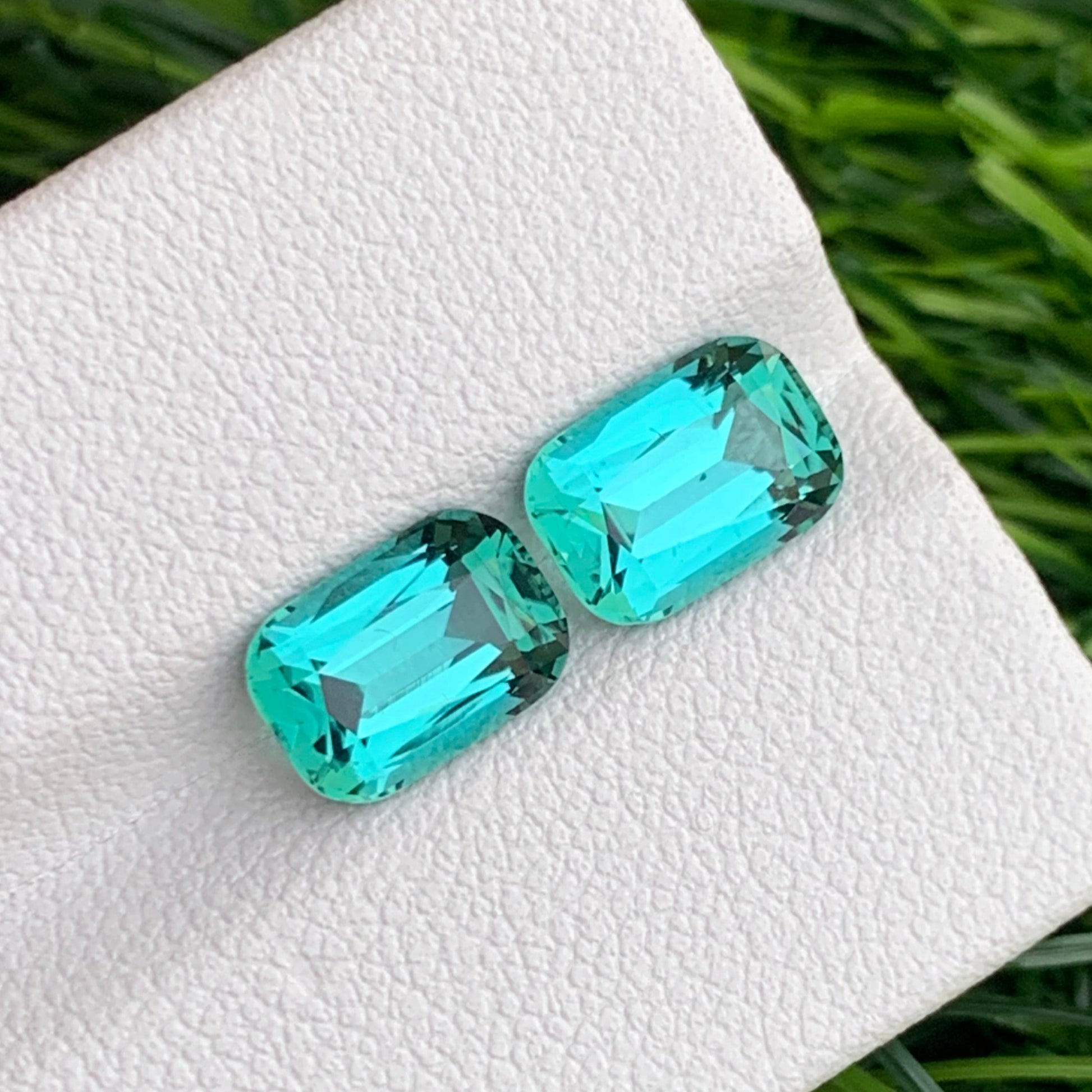  Bluish Green gemstone
 Bluish Green jewelry
luxury lagoon tourmaline pair vibrant color gemstones
cushion cut tourmaline pair blue green gemstones close up