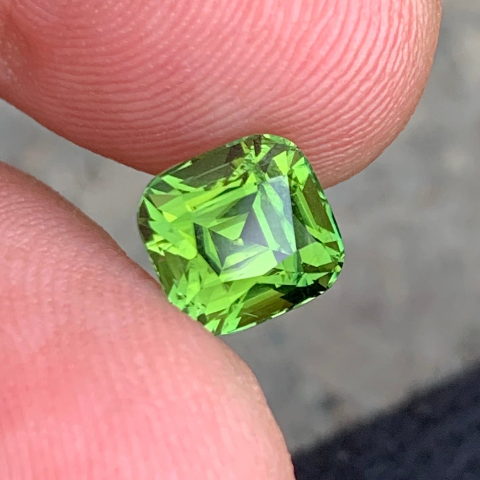 olive green tourmaline gemstone close up
green tourmaline gemstone cushion cut

