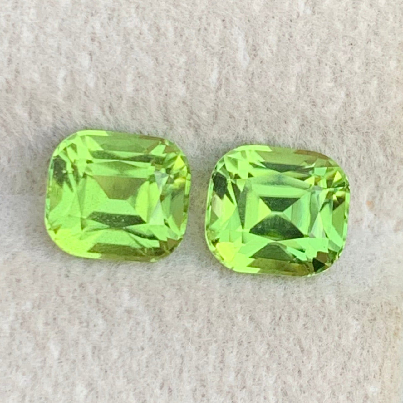 peridot gemstone pair from Pakistan
bright green peridot gemstones cushion cut
